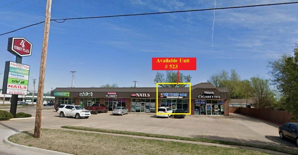 A strip mall with a highlighted vacant retail space for lease.