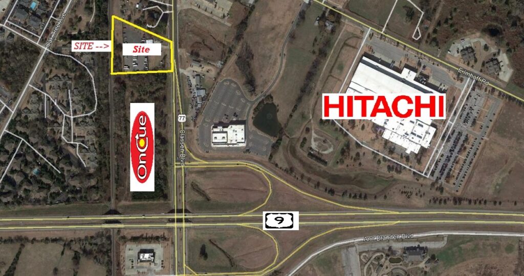 Aerial view of a highway intersection near HITACHI and SITE logos.