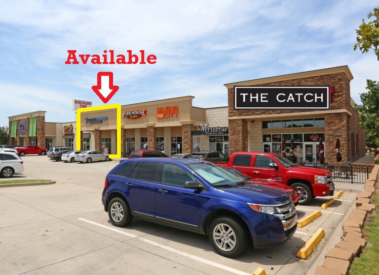 Storefronts in a shopping plaza with an 'Available' space highlighted.