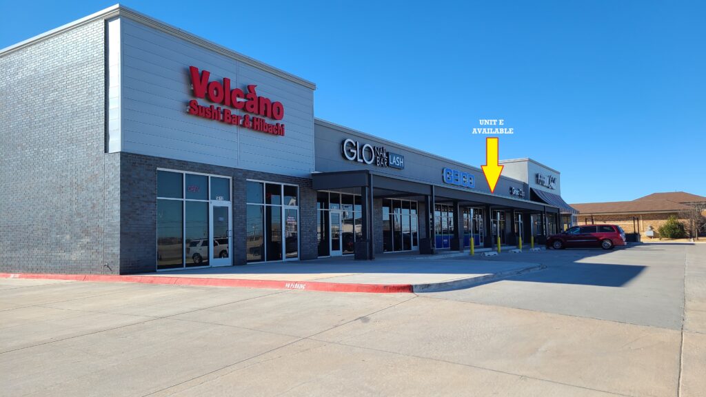 Exterior view of a retail plaza with signs for YoChina and CORE.