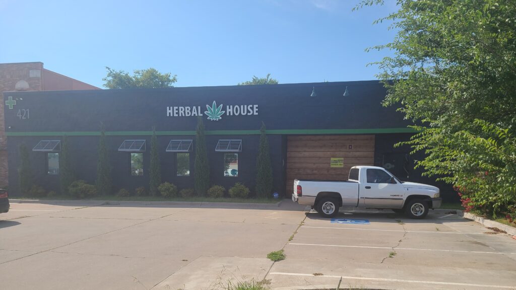 Exterior of Natural House with a pickup truck parked outside.