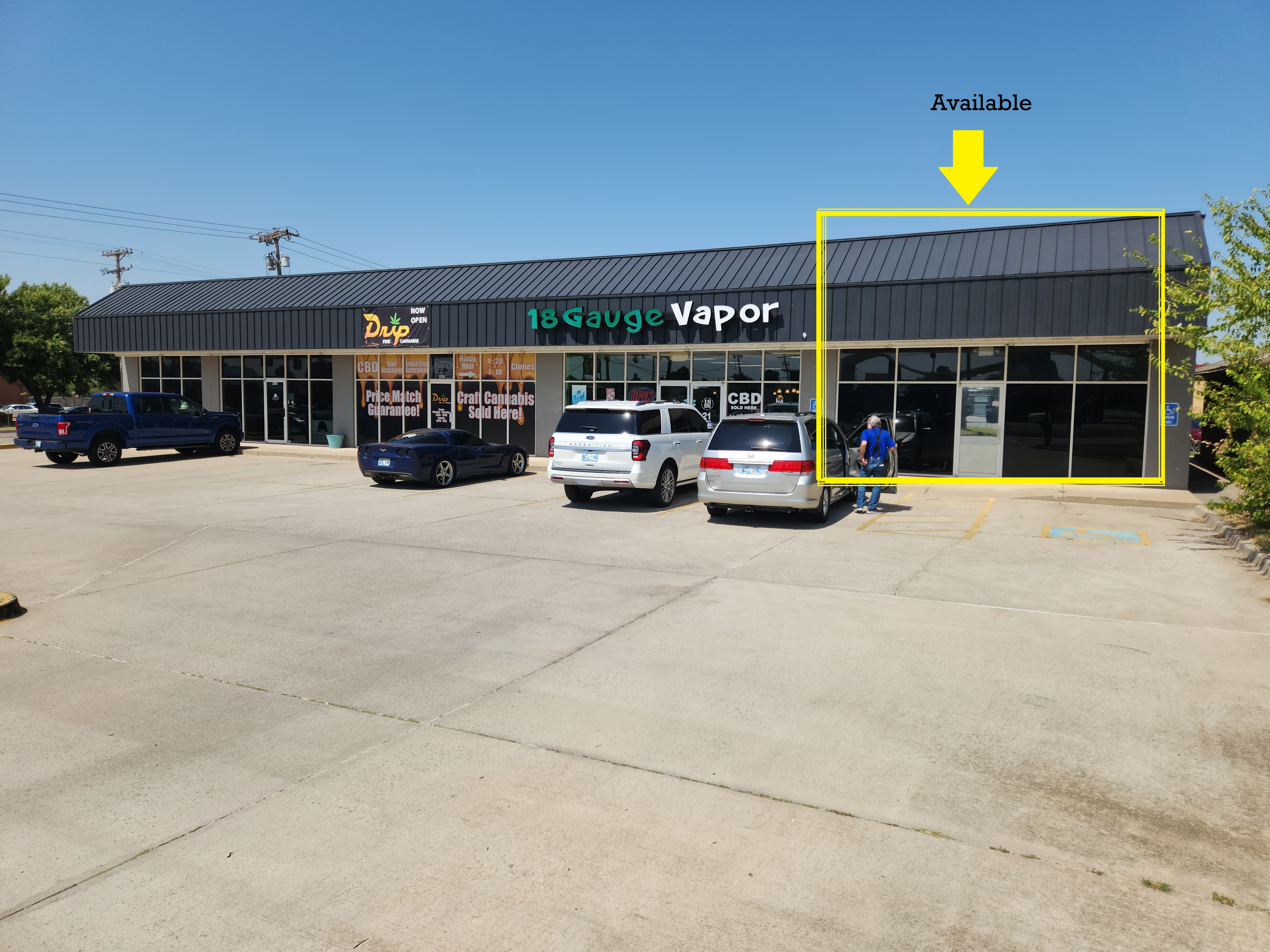 Strip mall with a vacant storefront marked as available for lease or rent.