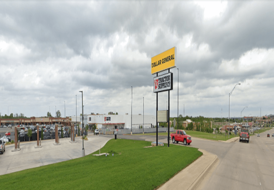 View of a gas station and convenience store on a cloudy day.